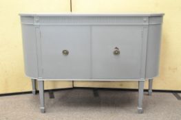 A Regency-style grey painted mahogany sideboard, of D-section with two cupboard doors,