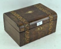 A late 19th century walnut sewing box adorned with inlaid parquetry decoration