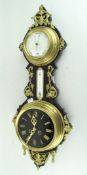 A wall barometer/clock, black mount adorned with gilt decoration,