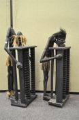 A pair of Tribal art carved wooden CD racks,