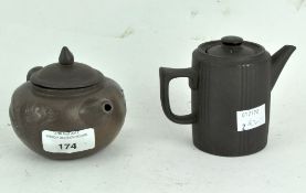 A Chinese pottery teapot together with another similar,