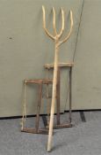 A wooden hay rake, formed out of a single piece of wood,