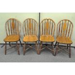 A set of four oak Windsor style kitchen chairs with X stretchers