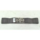 A modern Silver belt buckle attached to a fabric strap,