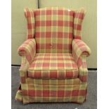 A wing back armchair, upholstered in tartan fabric,
