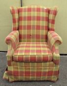 A wing back armchair, upholstered in tartan fabric,