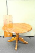 A pine circular extending dining table,