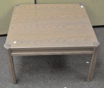 A modern coffee table of square form,