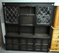 An oak display cabinet with leaded glass doors and panelled cupboards,