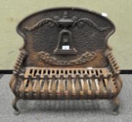 A Victorian cast iron ornate fire grate, the back adorned with urn finial,