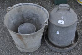 Two metal feeding troughs and a galvanised bucket,