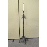 A wrought iron standard lamp,
