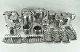 An extensive collection of stainless steel wares, including toast racks,