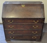 An 18th century oak bureau, with fall front enclosing drawers and pigeon holes,