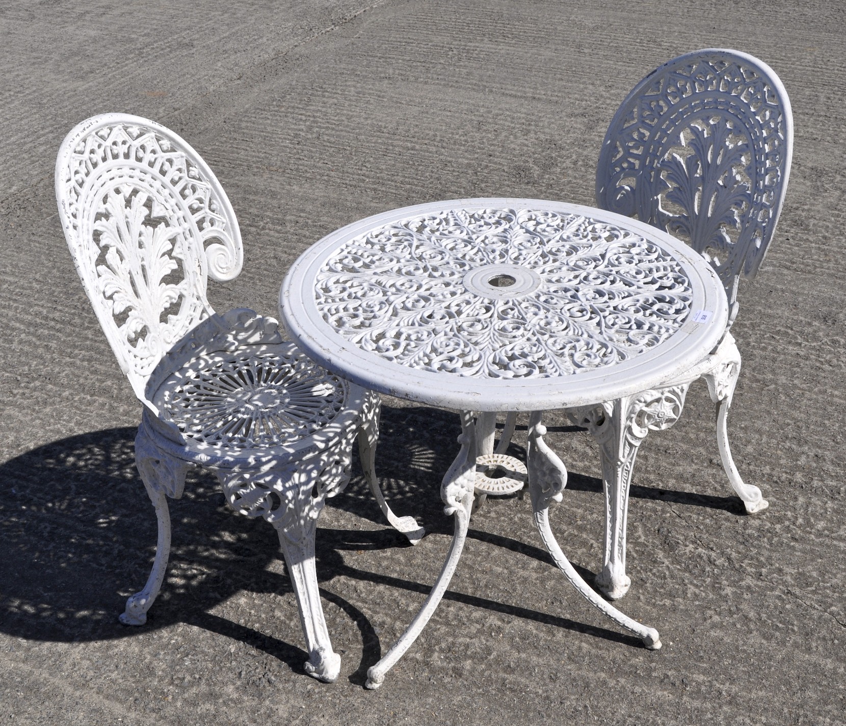 A white painted metal garden table, 64cm high x 68cm diameter,