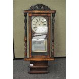 A late Victorian mahogany and inlaid wall clock, the dial with Roman numerals denoting hours,