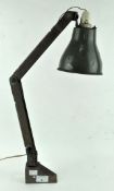 A vintage anglepoise style lamp with green enamel shade, fitted with a desk attachment,