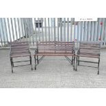 A garden bench and two chairs with cast metal ends,