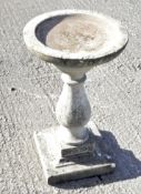 A reconstituted stone bird bath, of circular form on a square base, 44.