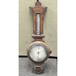 An early 20th century oak banjo cased aneroid barometer, with thermometer,