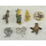 A selection of seven vintage brooches, to include a bird claw,