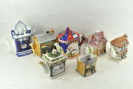A selection of vintage novelty shaped teapots, most in the form of cottages,