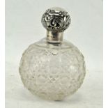 A late Victorian cut glass and silver mounted scent bottle of globular form,