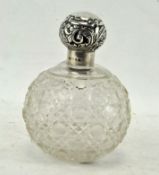 A late Victorian cut glass and silver mounted scent bottle of globular form,