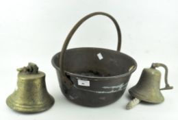 Two vintage brass bells, with clappers, and a jam pan, with loop handle,