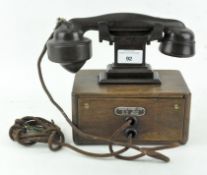 A vintage dictograph telephone system, bakelite on wooden base,