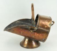 A copper coal scuttle with single swing handle,