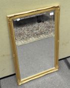 A gilt framed bevelled edged mirror of rectangular form,