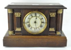 A late 19th/early 20th century oak cased mantel clock by Waterbury Clock Co,