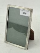 A vintage silver mounted photo frame, adorned with engine turned decoration,