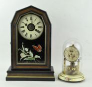 A German mantel clock, the ebonised case adorned with gilt detailing,
