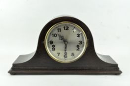 A Westminster chiming clock, mid-20th century, in oak arched rectangular case, with silvered dial,