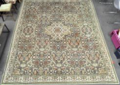 A large wool rug, with grey ground woven with foliate designs and lozenges in green, cream and pink,