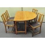 An oak drop-leaf table and four dining chairs, on barley twist legs,