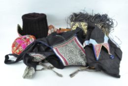 A collection of vintage clothing, including hats,
