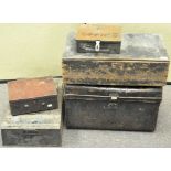 A collection of five metal and wooden storage trunks,