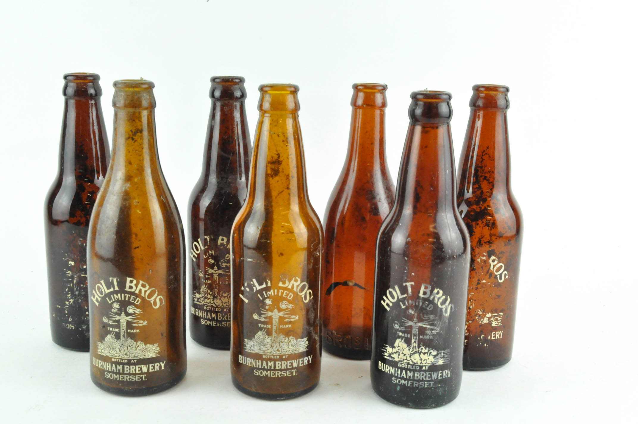A collection of vintage brown glass beer bottles, named for Holt's of Burnham Brewery, Somerset,