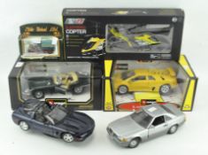 A collection of toy and model cars, including: Burago Jaguar, AV8 helicopter,