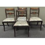 A set of four Victorian mahogany dining chairs with ribbon carved backs, each with drop-in seats,