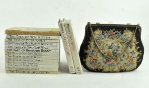 A group of books, including several by Beatrix Potter,