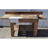 A vintage work bench with metal vice,