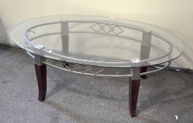 A glass topped coffee table, on metal frame and wooden legs,