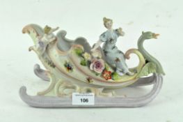 A Sitzendorf porcelain figure of a lady riding in a stylised swan chariot 25cm long