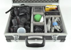 A Nikon camera travelling case containing three camera bodies