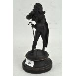 A small bronzed spelter figure of a Dandy, in fashionable dress, holding a cane,