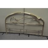 A large brass effect bed headboard,